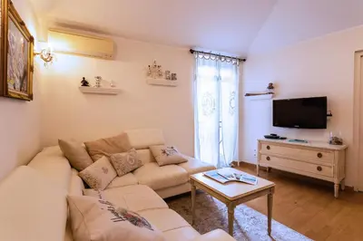 a living room with a couch and a tv at HEAVEN AP4440 By Riviera Holiday Homes in Villefranche-sur-Mer