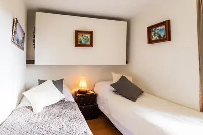 two beds in a room with white walls at HEAVEN AP4440 By Riviera Holiday Homes in Villefranche-sur-Mer