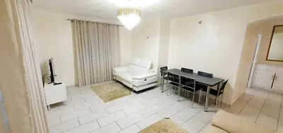 a living room with a white couch and a desk at Appartement 3 pièces sur Nice Centre in Nice