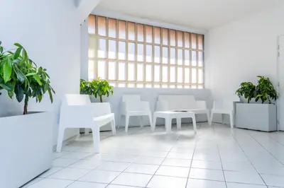 an office with white tables and white chairs and plants at NIce proche mer in Nice