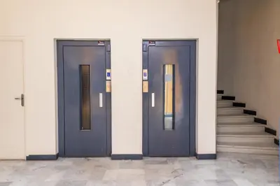 two blue doors in a building with stairs at NIce proche mer in Nice