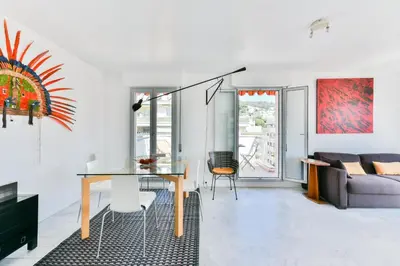 a living room with a table and a couch at Happyfew Fodere in Nice
