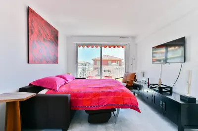 a bedroom with a large bed with a red blanket at Happyfew Fodere in Nice