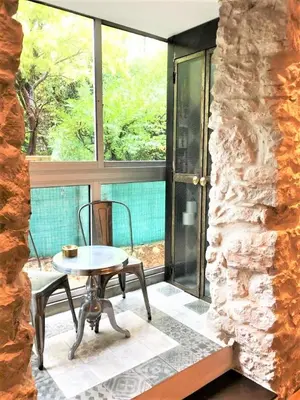 a room with a table and chairs and a large window at COCON AP4446 By Riviera Holiday Homes in Villefranche-sur-Mer