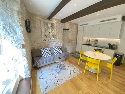 a living room with a couch and a table at COCON AP4446 By Riviera Holiday Homes in Villefranche-sur-Mer