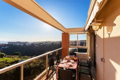 a balcony with a table and chairs on it at LE JARDIN BLEU AP4388 By Riviera Holiday Homes in Nice