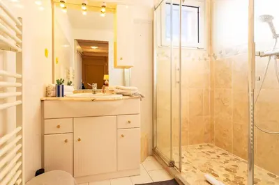 a bathroom with a sink and a shower at LE JARDIN BLEU AP4388 By Riviera Holiday Homes in Nice