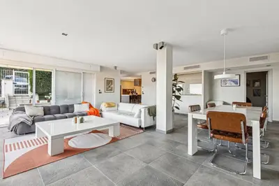 a living room with a couch and a table at Bay of Angels by ecoflats in Nice