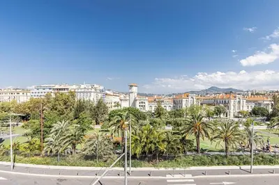 a city with buildings and palm trees and a street at 2 chambres, balcons, vue imprenable, climatisation - PALACE BLEU in Nice