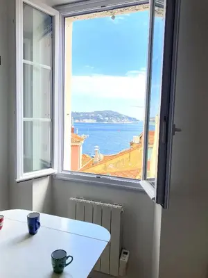 a window in a room with a view of the ocean at PEARL AP4444 By Riviera Holiday Homes in Villefranche-sur-Mer