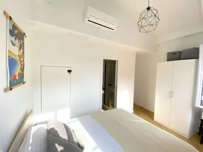 a white bedroom with a bed and white cabinets at PEARL AP4444 By Riviera Holiday Homes in Villefranche-sur-Mer