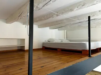a loft bed in a room with a wooden floor at Cosy Studio Climatisé en plein cœur de Nice in Nice