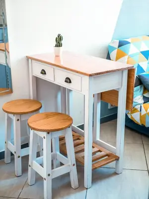 a desk and two stools next to a bed at PORT - Charmant Studio in Nice