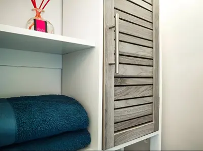 a closet with a wooden door with a blue blanket at PORT - Charmant Studio in Nice