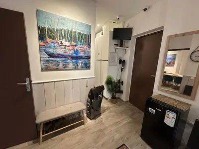 a room with a painting of a boat on the wall at Promenade des Anglais With AC Near Negresco in Nice