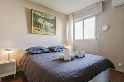 a bedroom with a bed with two towels on it at Appartement cosy Cagnes-sur-Mer in Cagnes-sur-Mer