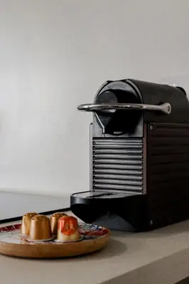 a toaster with a plate of food on a table at Appartement cosy Cagnes-sur-Mer in Cagnes-sur-Mer