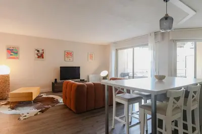 a living room with a table and a couch at Appartement cosy Cagnes-sur-Mer in Cagnes-sur-Mer