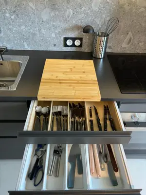 a kitchen counter with a drawer filled with cooking utensils at NICE La Palmeraie Pool BEACH AC in Nice
