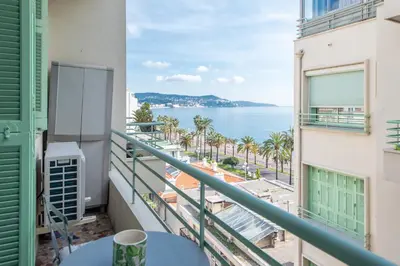 a balcony with a view of the ocean at Happyfew Le Miramar in Nice