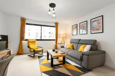 a living room with a couch and a table at Suite Matisse FSHH - Generale in Nice