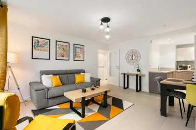 a living room with a couch and a table at Suite Matisse FSHH - Generale in Nice