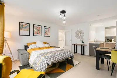 a bedroom with a bed and a kitchen at Suite Matisse FSHH - Generale in Nice