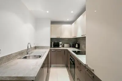 a kitchen with white cabinets and a sink at Suite Matisse FSHH - Generale in Nice