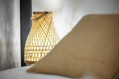 a lamp sitting next to a bed in a room at FEEL HOME - Poissonnerie in Nice