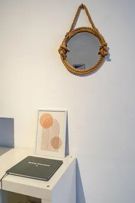a table with a mirror and a book on it at Vieux-Nice 2P climatisé Balcon in Nice