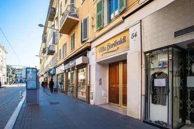 a street with shops on the side of a building at Garibaldi AP4447 By Riviera Holiday Homes in Nice