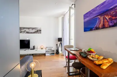 a living room with a table with food on it at Garibaldi AP4447 By Riviera Holiday Homes in Nice