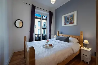 a bedroom with a bed with a tray of food on it at Seabreeze Apt Nice Port in Nice