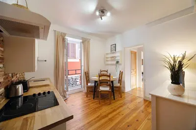 a kitchen with a table and a dining room at Seabreeze Apt Nice Port in Nice