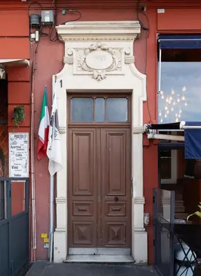 a door to a building with a clock above it at Seabreeze Apt Nice Port in Nice