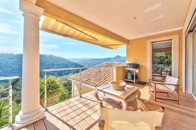a balcony with a view of the mountains at VILLA NIDAZUR VI4413 By Riviera Holiday Homes in Nice