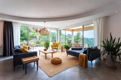 a living room with couches and chairs and a table at VILLA NIDAZUR VI4413 By Riviera Holiday Homes in Nice