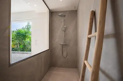 a walk in shower in a bathroom with a window at VILLA NIDAZUR VI4413 By Riviera Holiday Homes in Nice