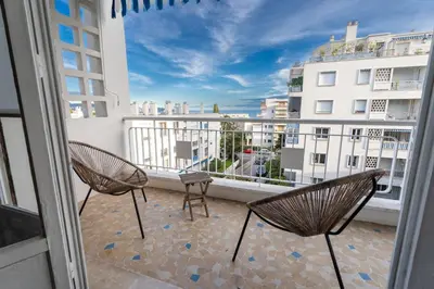 two chairs on a balcony with a view of a building at Il Sole e Mare in Nice