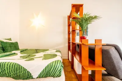 a bedroom with a bed and a book shelf at Il Sole e Mare in Nice