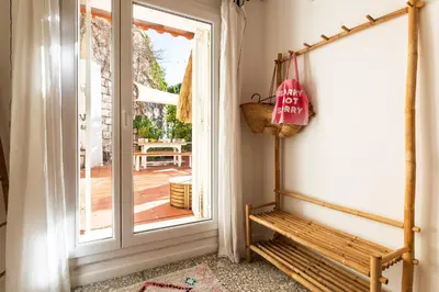 a porch with a bench next to a door at CASA ROSALIE VI4442 By Riviera Holiday Homes in Villefranche-sur-Mer
