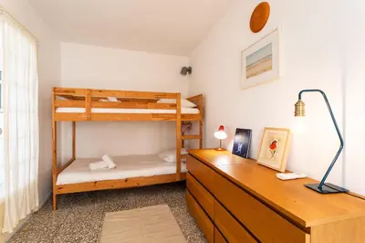 a bedroom with two bunk beds and a desk at CASA ROSALIE VI4442 By Riviera Holiday Homes in Villefranche-sur-Mer