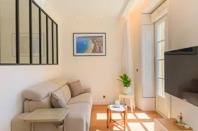 a living room with a couch and a table at Hyper Centre, balcon, 5min de la plage, AC in Nice