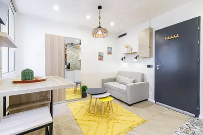 a kitchen and living room with a table and a chair at Ultra Central 1 Bdr - AC in Nice