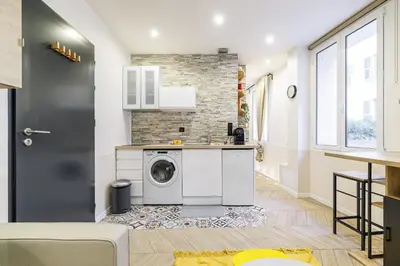 a kitchen with a washer and dryer in a apartment at Ultra Central 1 Bdr - AC in Nice