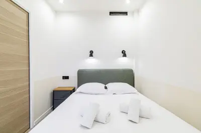 a bedroom with a white bed with two pillows at Ultra Central 1 Bdr - AC in Nice