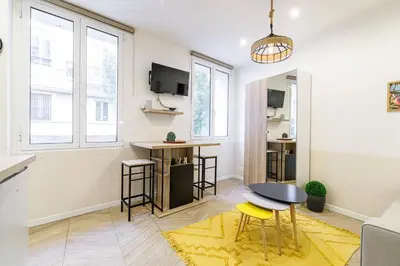 a living room with a table and some stools at Ultra Central 1 Bdr - AC in Nice