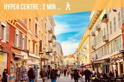 a group of people walking down a city street at Studio T1 Centre - Idéal couple & amis - Confort - WIFI - Calme - Climatisation - Coin Terrasse in Nice