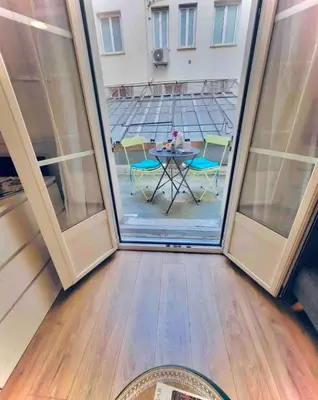 a room with a table and chairs through a window at Studio T1 Centre - Idéal couple & amis - Confort - WIFI - Calme - Climatisation - Coin Terrasse in Nice