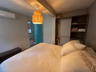 a bedroom with a white bed with a light at Les Magnolias 06 in Nice